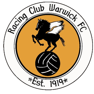 Racing Club Warwick FC logo: winged horse atop a football inside an orange circle, white ring with the club name and 'Est. 1919'