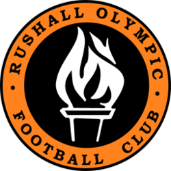 Rushall Olympic Football Club logo: orange ring with black center and white flame emblem in the middle.