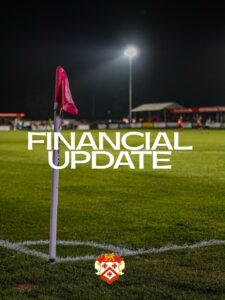 Nighttime soccer field with pink corner flag and bold 'FINANCIAL UPDATE' text overlay; club crest at bottom center, indicating a financial news post for the team.